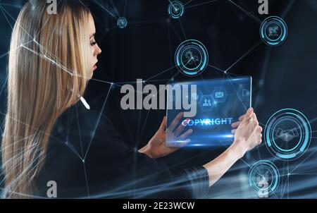 Business, Technology, Internet and network concept. Young businessman working on a virtual screen of the future and sees the inscription: Copyright Stock Photo