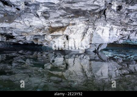 Underground Lake Inside the Ice Cave. Slope of the mountain with the reflection in the water inside a fantastic cave. Kungur In The Urals, Russia Stock Photo