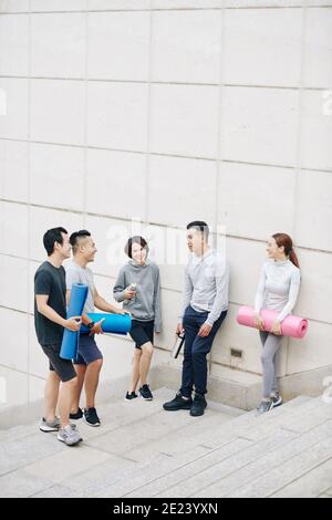 Young people discussing yoga training Stock Photo