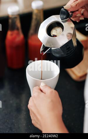 Woman making black coffee Stock Photo