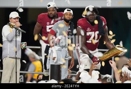 Miami, United States. 12th Jan, 2021. Alabama Crimson Tide offensive lineman Alex Leatherwood (70) and injured wide receiver DeVonta Smith (C) gather with head coach Nick Saban (L) and defensive lineman Christian Barmore after a 52-24 win over the Ohio State Buckeyes in the 2021 NCAA National Championship football game at Hard Rock Stadium in Miami on Monday, January 11, 2021. The win delivered Saban's seventh national championship. Photo by Hans Deryk/UPI Credit: UPI/Alamy Live News Stock Photo