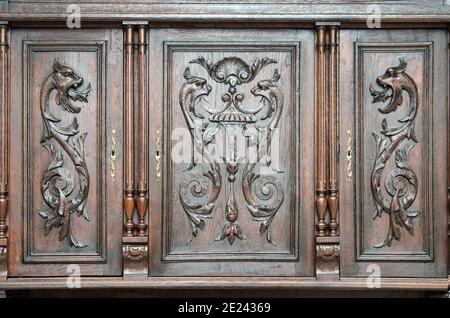 Part of old  kitchen sideboard as example of beautiful wood engraving as background. Stock Photo