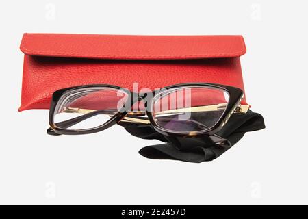Rectangular plastic oversized eyeglasses with red glasses leather case, and black microfiber cleaning cloth isolated on white background Stock Photo