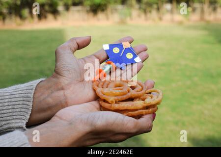 cute miniature toy kite with miniature cute toy spool manjha in park. On occasion of kite flying festival of uttarayan or makar sankranti festivalJale Stock Photo