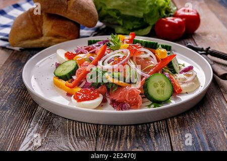 Delicious and healthy food. Salad with smoked trout, grapefruit, fresh cucumber, purple Chinese cabbage sweet peppers. Mediterranean diet recipes. Low Stock Photo