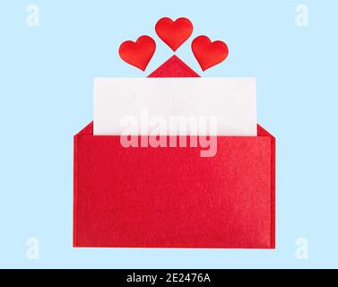 Red open envelope with a sheet of paper with a hearts on a blue background with mock-up. Valentines day holidays concept and love notes, christmas and Stock Photo