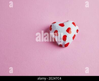 Valentine's day banner with candy hearts on pink background. Top view with a place for your greetings Stock Photo