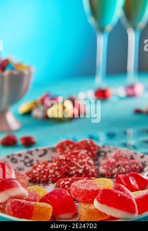 Valentine's day or romantic dinner with candy hearts, glasses of champagne and elegant table setting and Valentine's Day lettering on a light blue Stock Photo