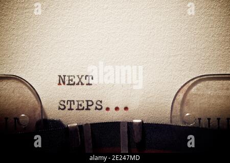 Next steps phrase written with a typewriter. Stock Photo