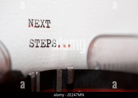 Next steps phrase written with a typewriter. Stock Photo