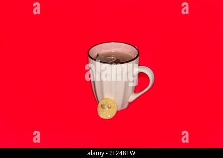 green tea with lemon white cup in red background Stock Photo
