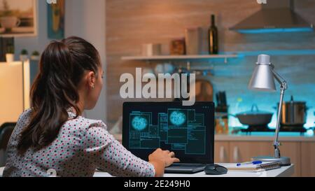 Hacker woman finishing succesfully hacking company system stealing database company. Programmer writing a dangerous malware for cyber attacks using performance laptop during midnight. Stock Photo