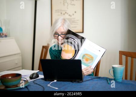 Woman using laptop at home Stock Photo