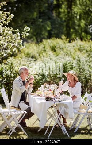 Couple having meal in garden Stock Photo