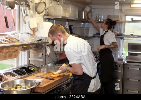 Man and woman working in restaurant kitchen Stock Photo