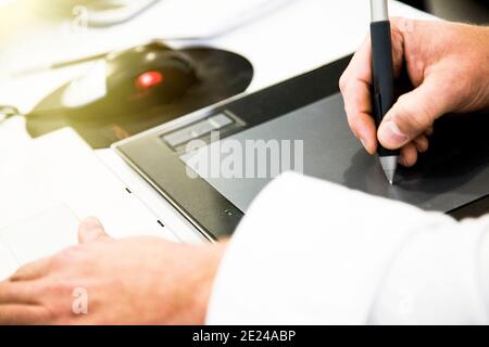 Graphic designer working on drawing board Stock Photo