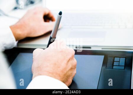 Graphic designer working on drawing board Stock Photo