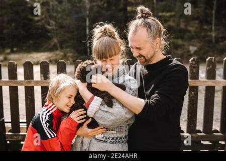 Parents standing with daughter Stock Photo