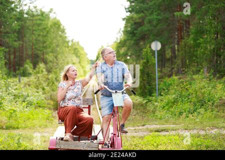Couple riding handcar Stock Photo