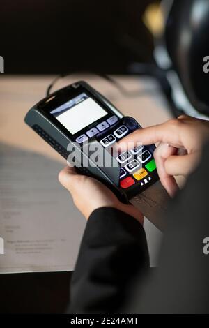 Close-up of hands holding credit card reader Stock Photo