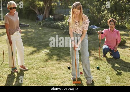 Family plying croquet in garden Stock Photo