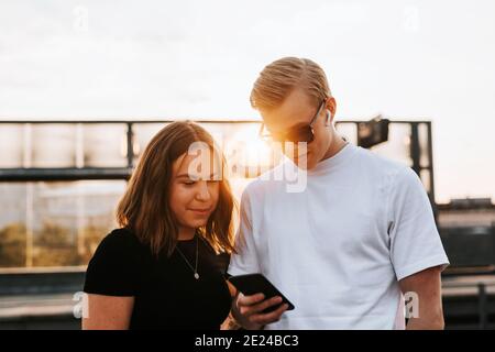 Young friends looking at cell phone Stock Photo