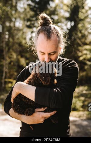 Man kissing dog Stock Photo