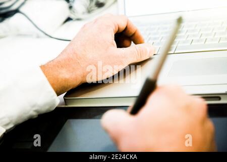 Graphic designer using laptop and drawing board Stock Photo