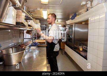 Man working in restaurant kitchen Stock Photo