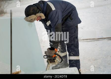 Workman assembler customize chainsaw ice plate Stock Photo