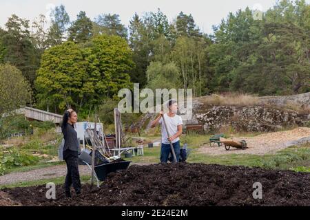 Young couple digging in garden Stock Photo