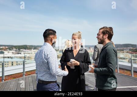 Coworkers talking during coffee break Stock Photo