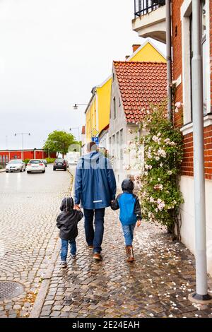 Rear view of father and children walking hand in hand Stock Photo - Alamy