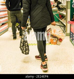 London UK, Customers Carrying  Baskets Shopping In Waitrose Food Supermarket Foe Essential Items During Covid-19 Pandemic Lockdown Stock Photo