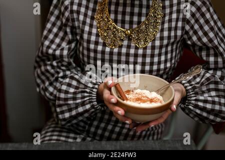 Mid section of woman holding bowl with Risgrynsgrˆt Stock Photo