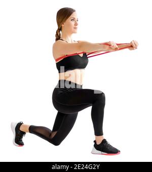 Woman doing a power band behind lunge and forward push exercise to strengthen her core muscles using resistance isolated on white background in a heal Stock Photo