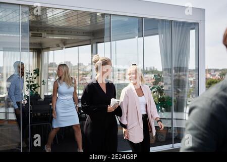 Coworkers talking during coffee break Stock Photo