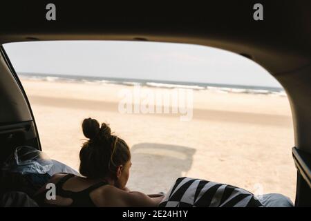 Woman in car looking at view Stock Photo