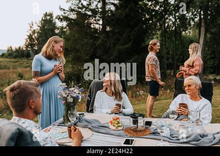 Friends talking in garden Stock Photo