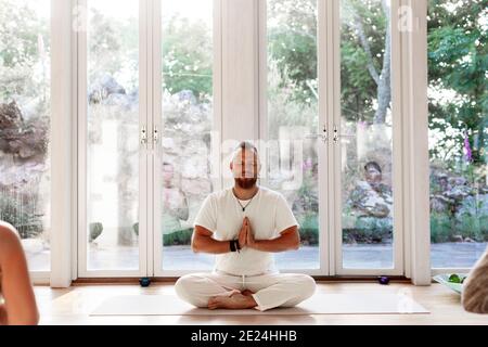 Man practicing yoga in studio Stock Photo