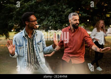 Male friends having fun in park Stock Photo