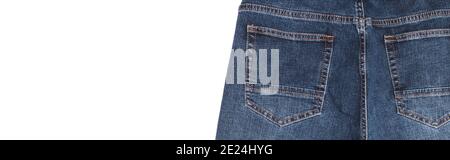 Back pockets and waist area of dark blue jeans isolated on white background. Close up shot. Copy space. Banner size. Clothing concept. Stock Photo