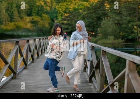 Female friends doing footshake Stock Photo