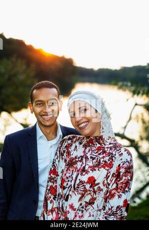 Couple standing at lake Stock Photo