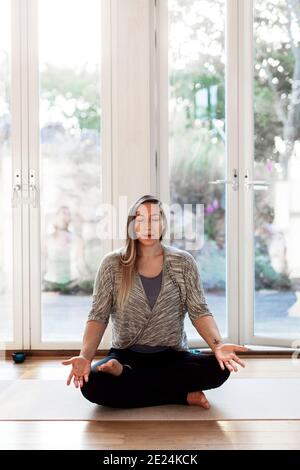 Woman practicing yoga in studio Stock Photo