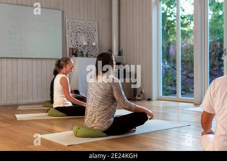 Women practicing yoga in class Stock Photo