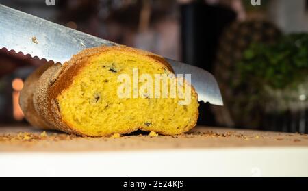 Home made sweet braided yellow bread with raisins, sliced with bread knife. Selective focus Stock Photo