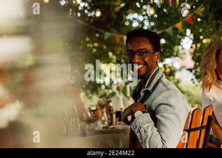 Man sitting at table in garden Stock Photo