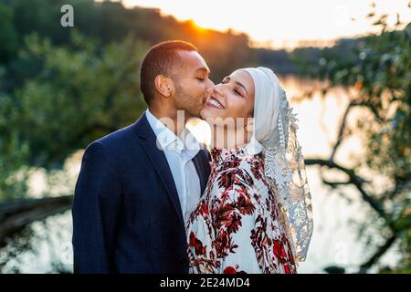 Couple standing at lake Stock Photo