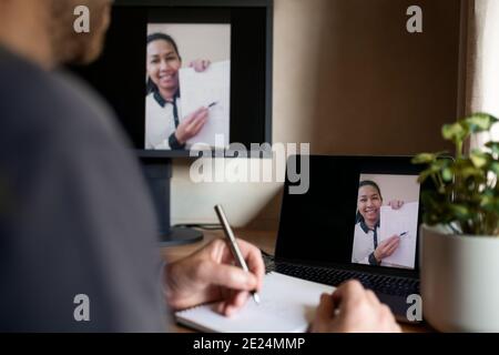 Smiling woman on laptop screen during video call Stock Photo